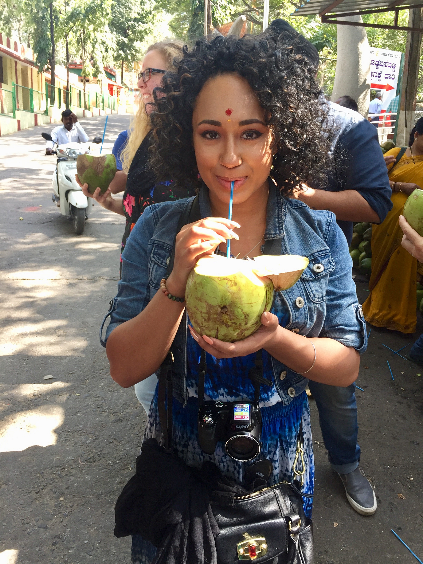 Female student drinking from coconut