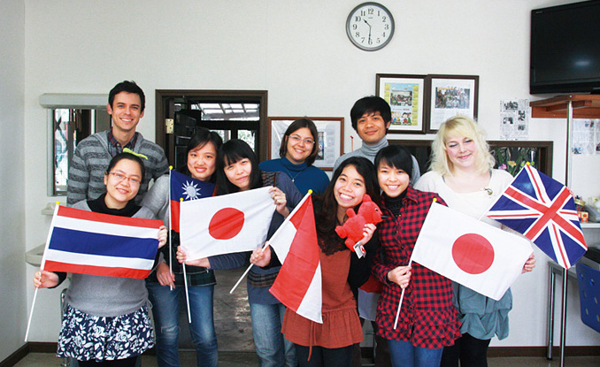 international office with students from all over the world holding up flags