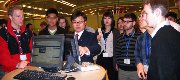 students at a tech show in Shanghai, getting instruction from a leader.