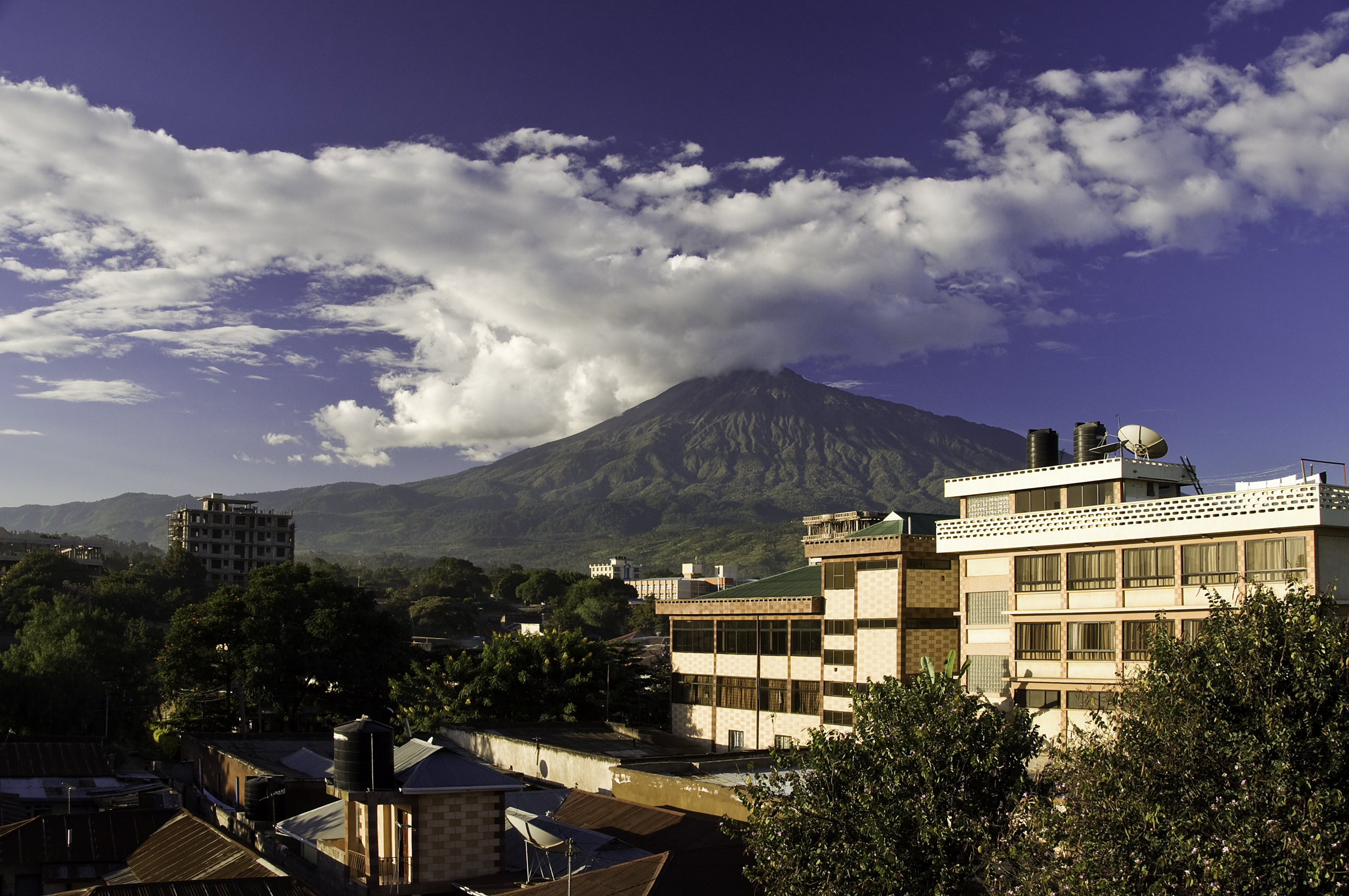 Mount Kilamanjaro behind Arusha buildings