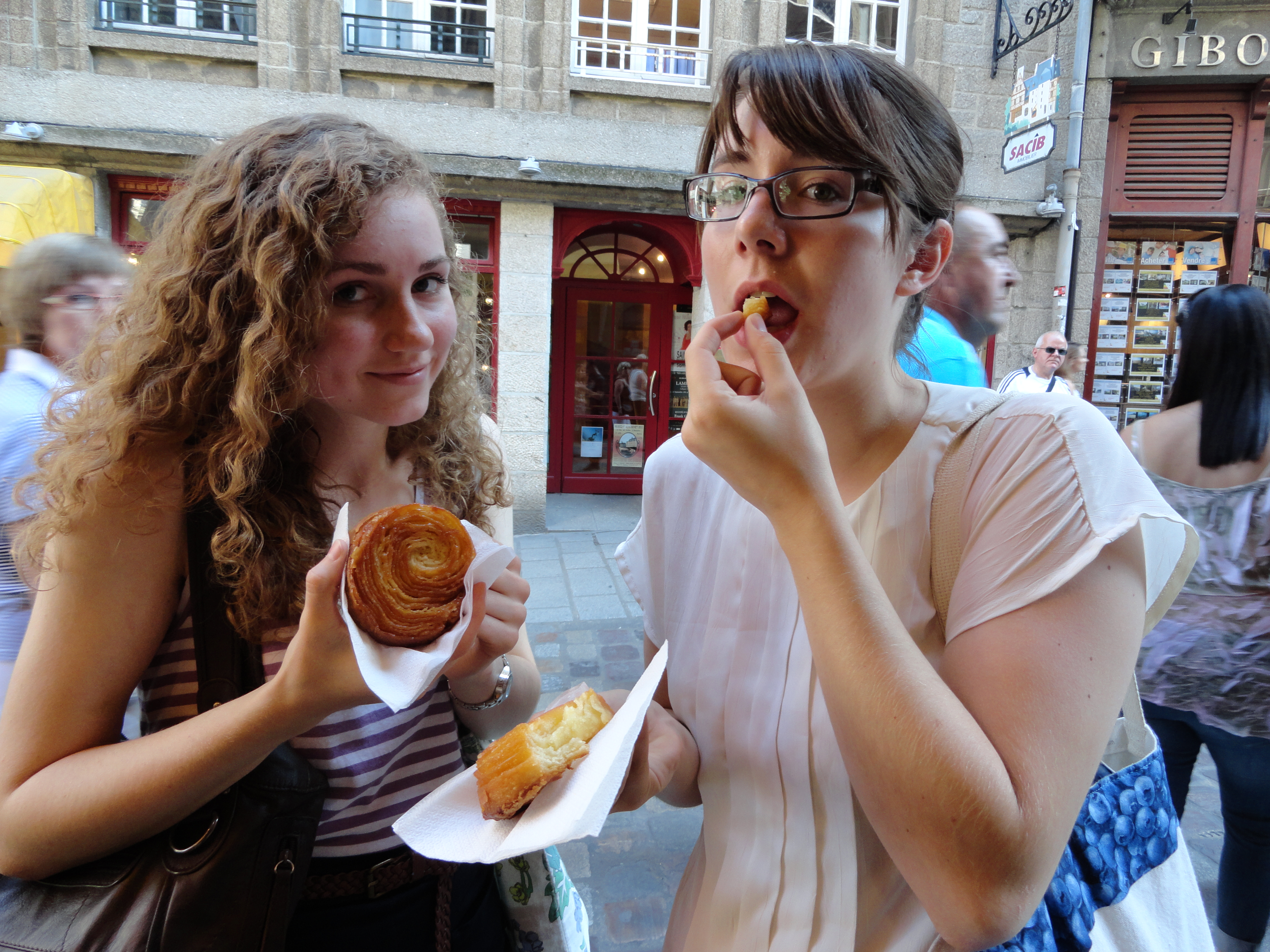 two students eating pastries
