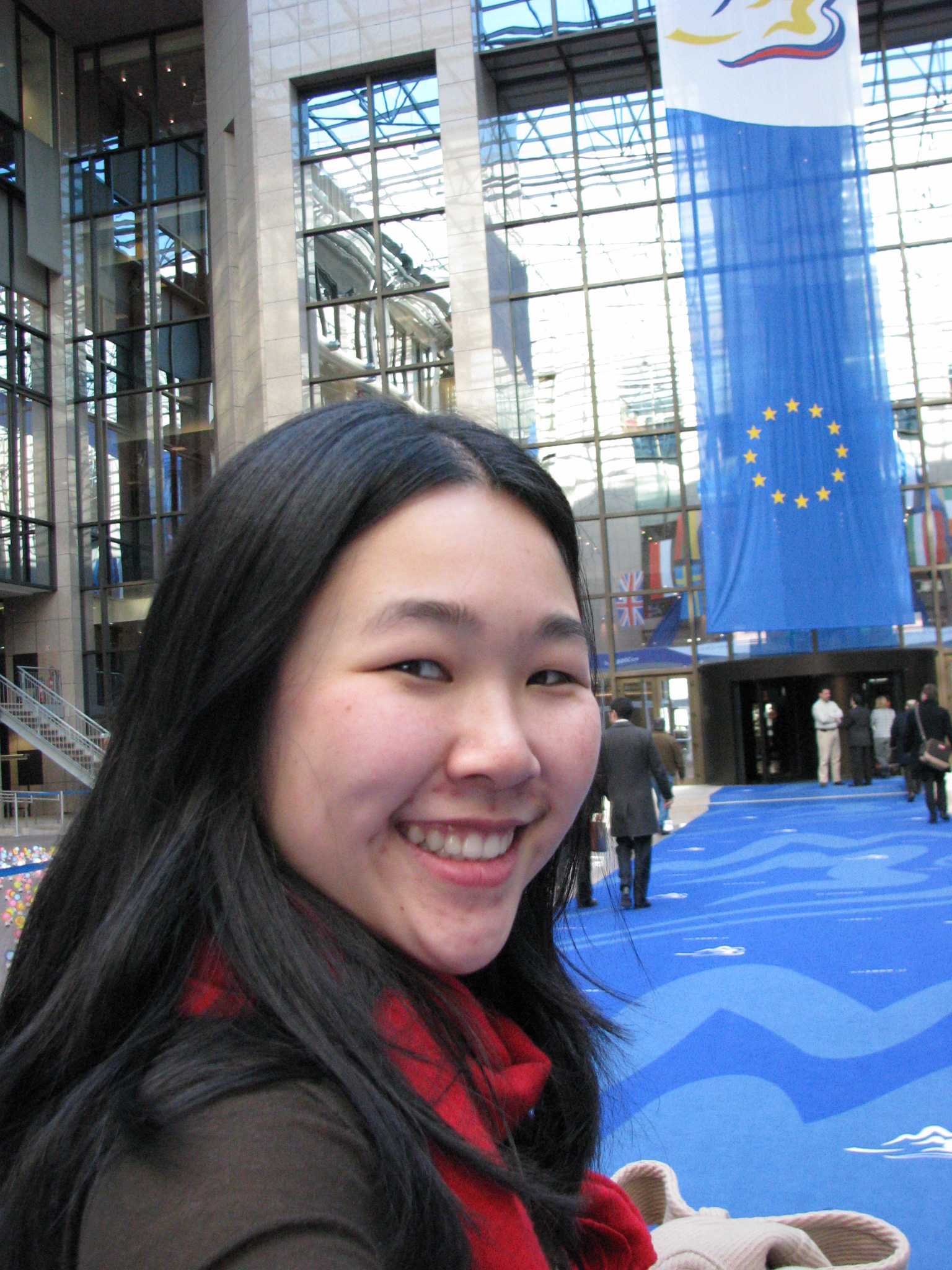 student in front of a European Union flag