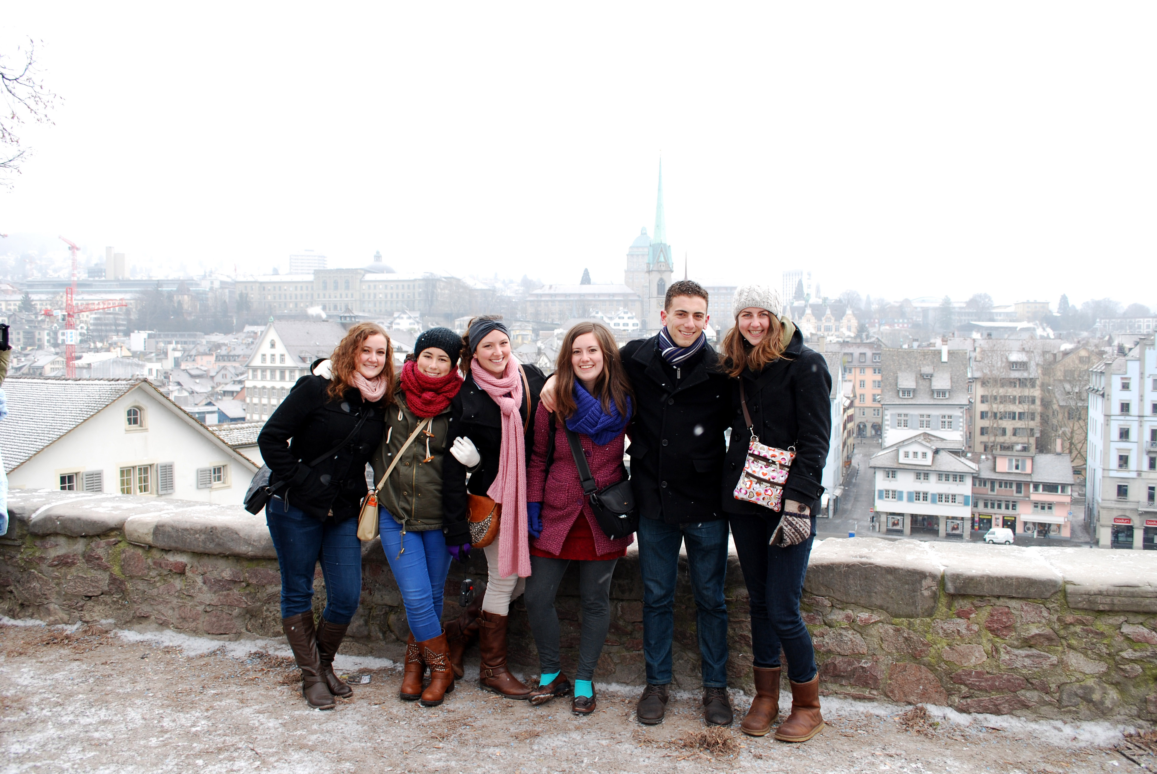 group of six students standing in front of Zurich skyline in the snow